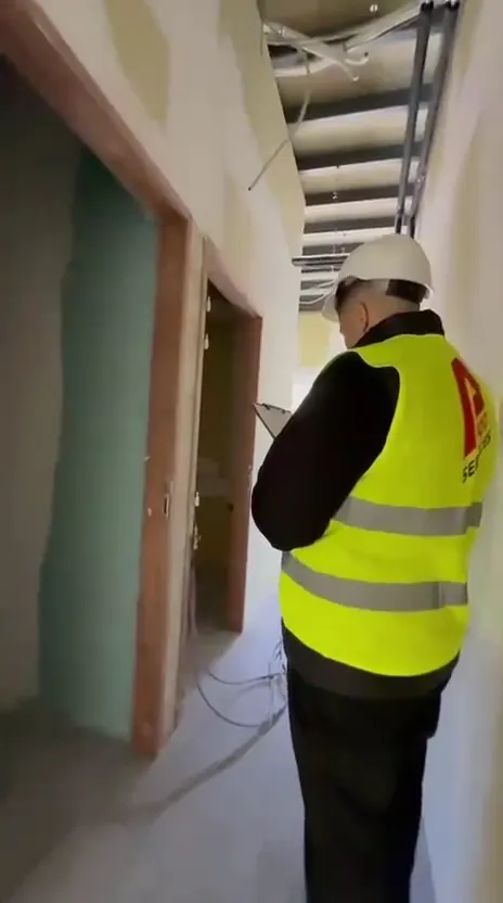 Un membre de l'équipe en gilet P300 Services dans des locaux en travaux